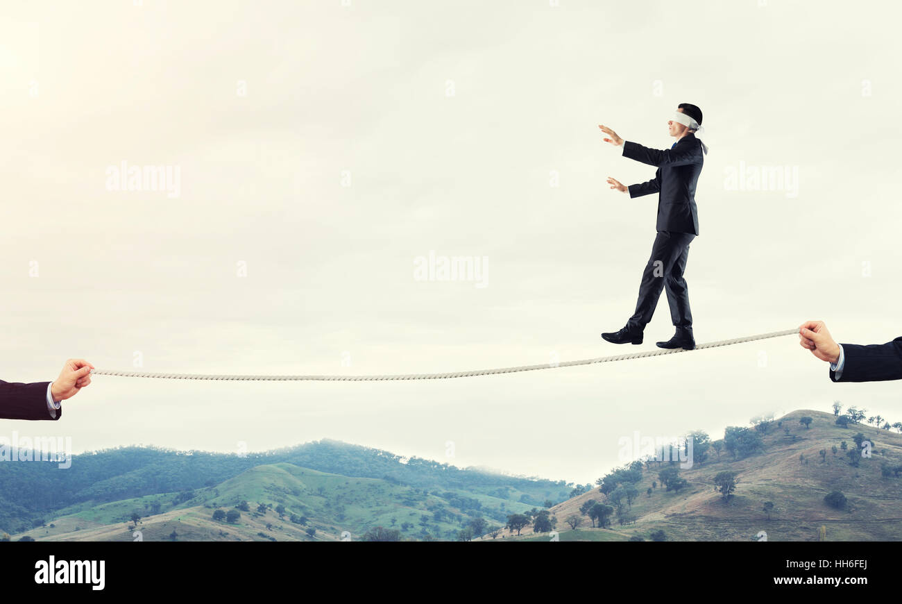 Business concept of risk support and assistance with man balancing on ...