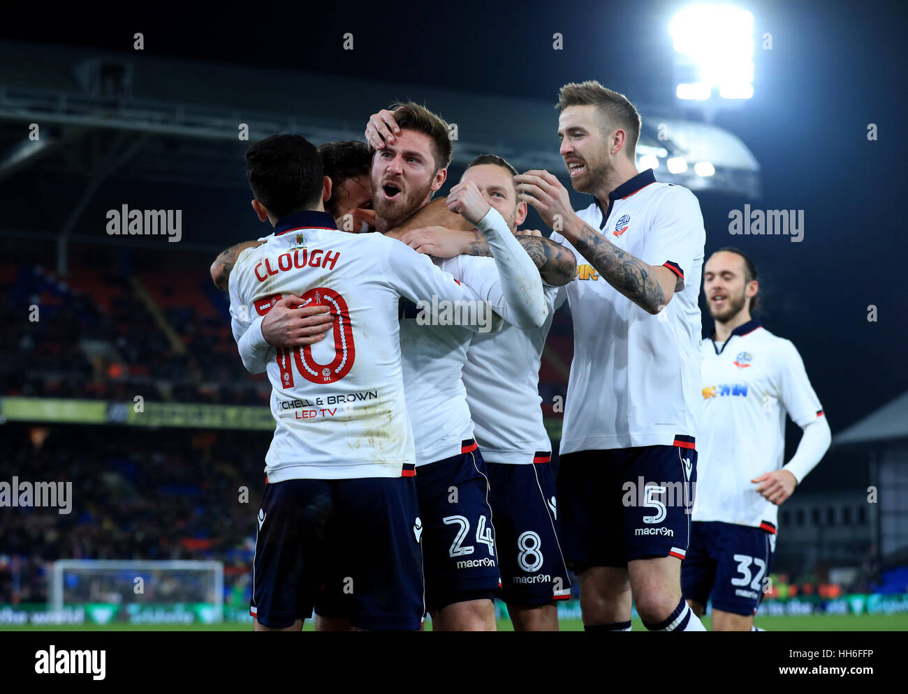 Bolton Wanderers' James Henry (no.24) celebrates scoring his side's first goal of the game with team-mates during the Emirates FA Cup, third round replay match at Selhurst Park, London. Stock Photo