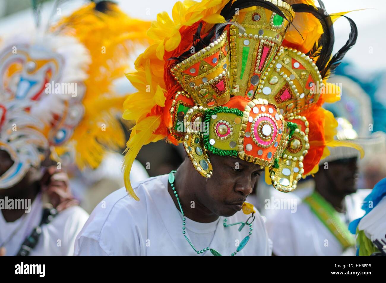 musician in carnival dress in a Junkanoo band playing in a street parade on Nassau Bahamas Stock Photo