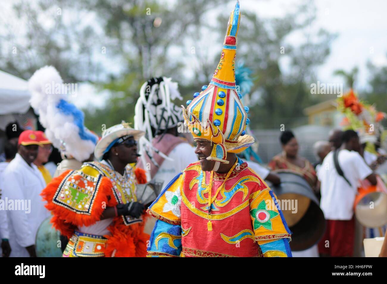 man in carnival dress in a Junkanoo band playing in a street parade on Nassau Bahamas Stock Photo