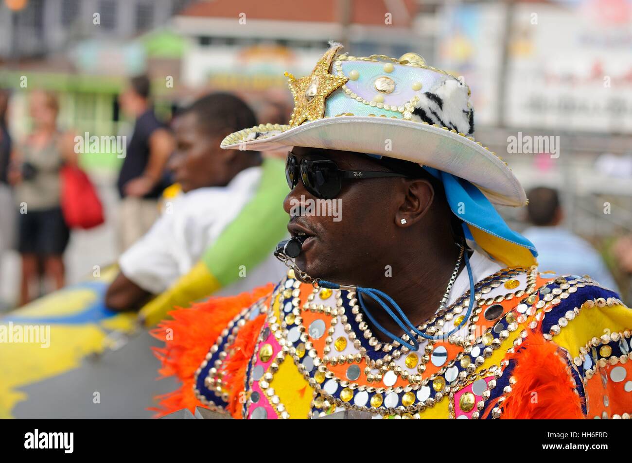 bandsman in carnival dress in a Junkanoo band playing in a street parade on Nassau Bahamas Stock Photo