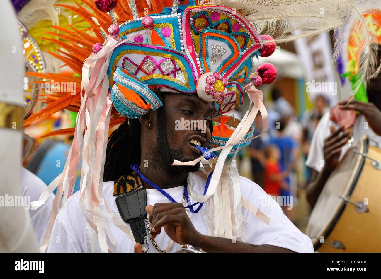 drummer in carnival dress in a Junkanoo band playing in a street parade on Nassau Bahamas Stock Photo