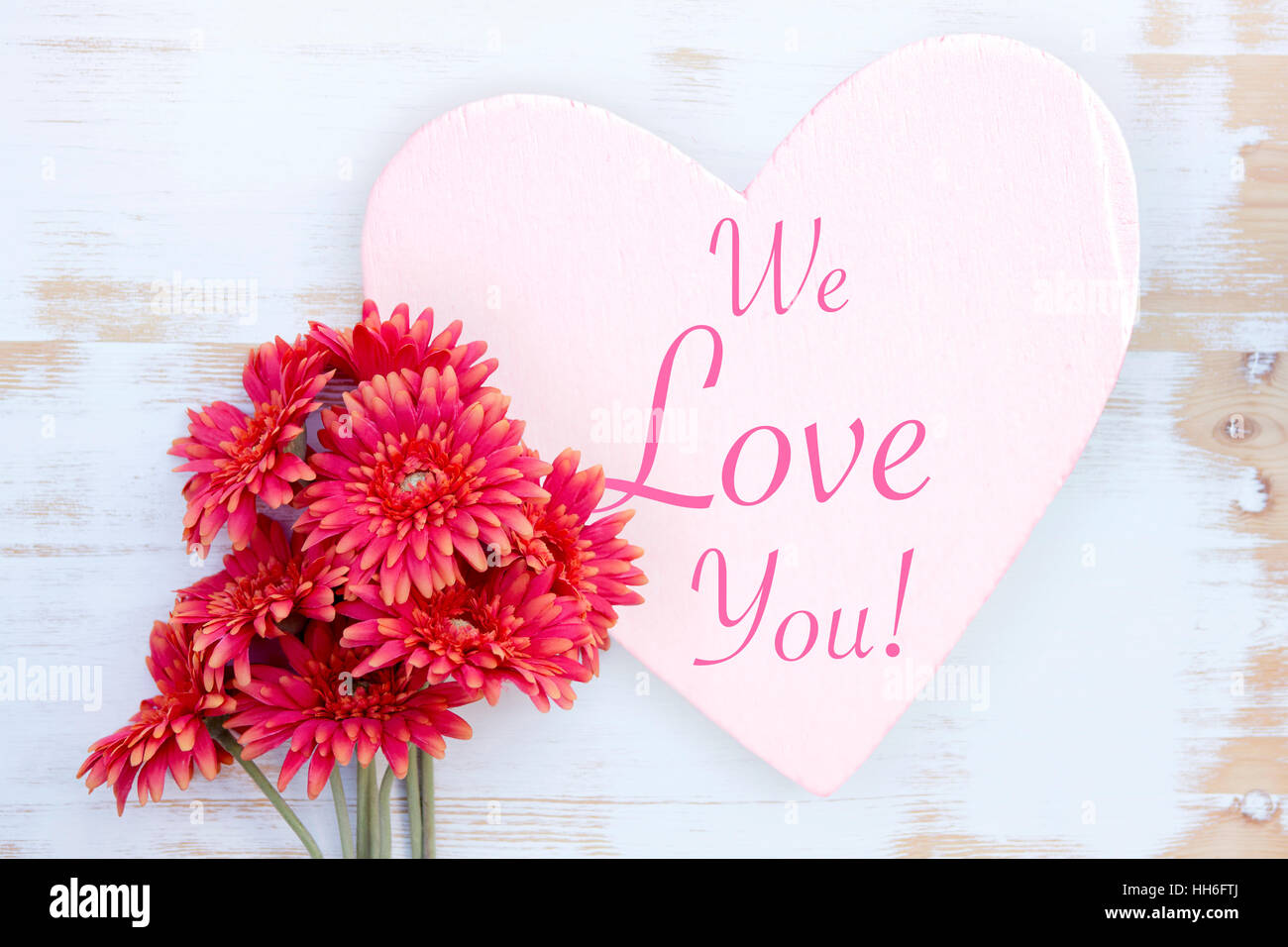 beautiful red flowers and wooden heart with words We Love You ...