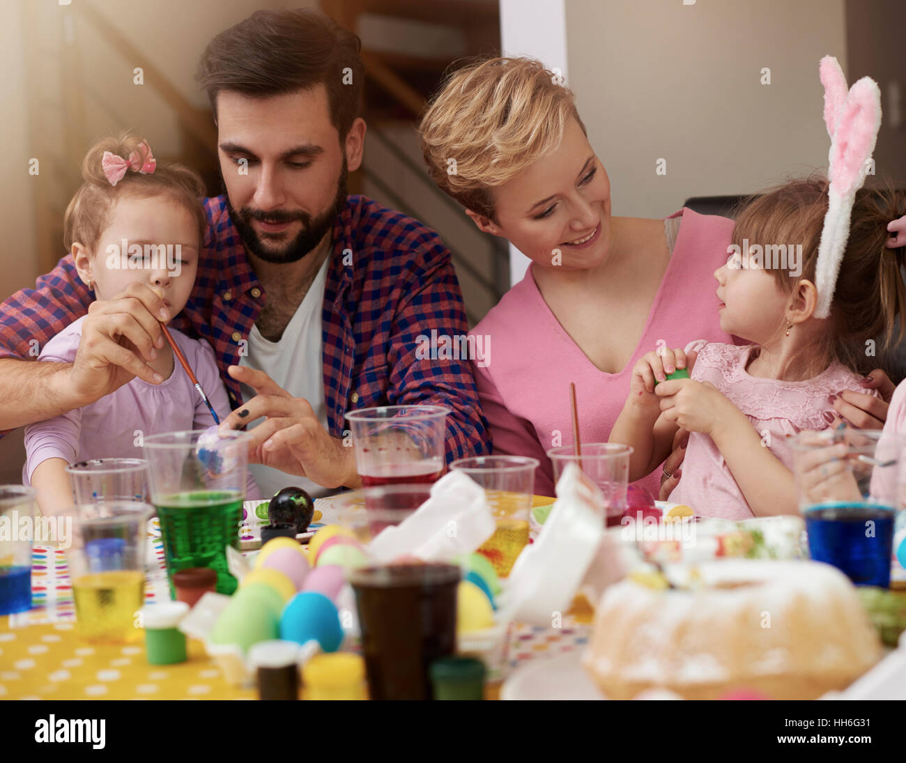 Mother and father spending time with their little girls Stock Photo