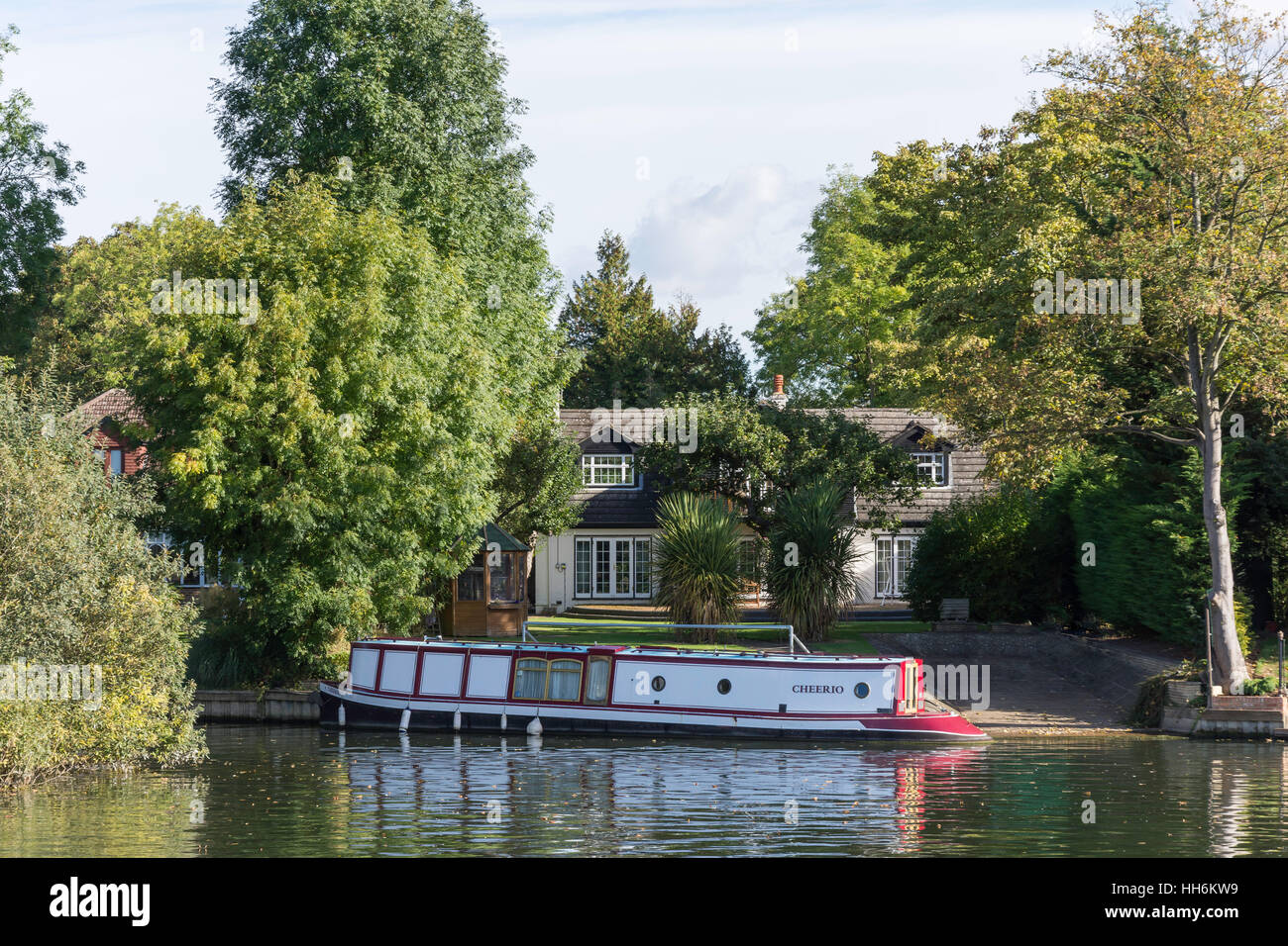 Riverside house and canal boat by River Thames, Runnymede, Surrey, England, United Kingdom Stock Photo