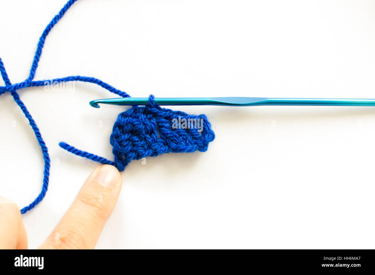 Crochet hook and wool on white background Stock Photo