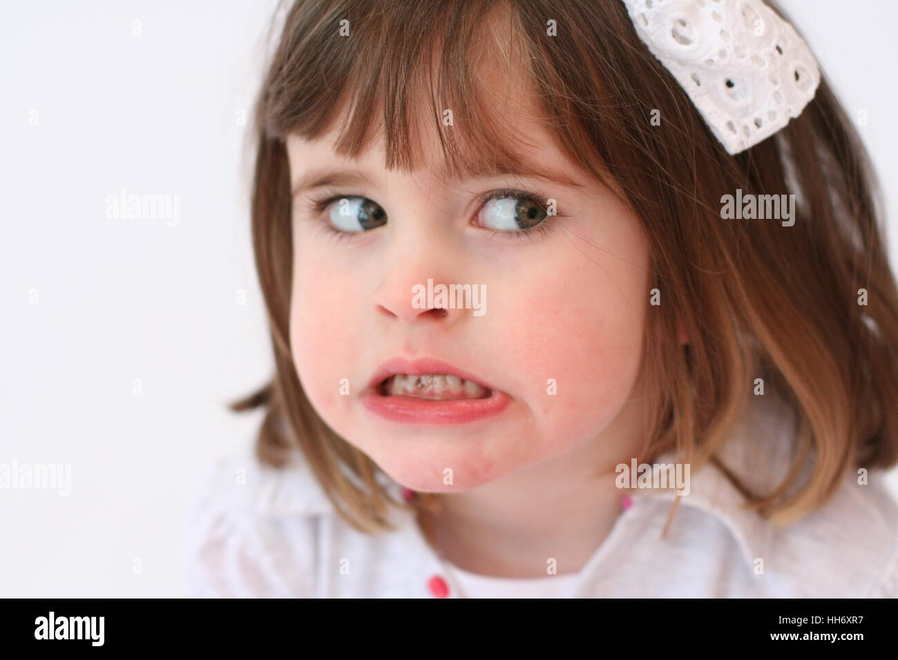 Little girl, child making a funny angry face, grinding her teeth Stock Photo