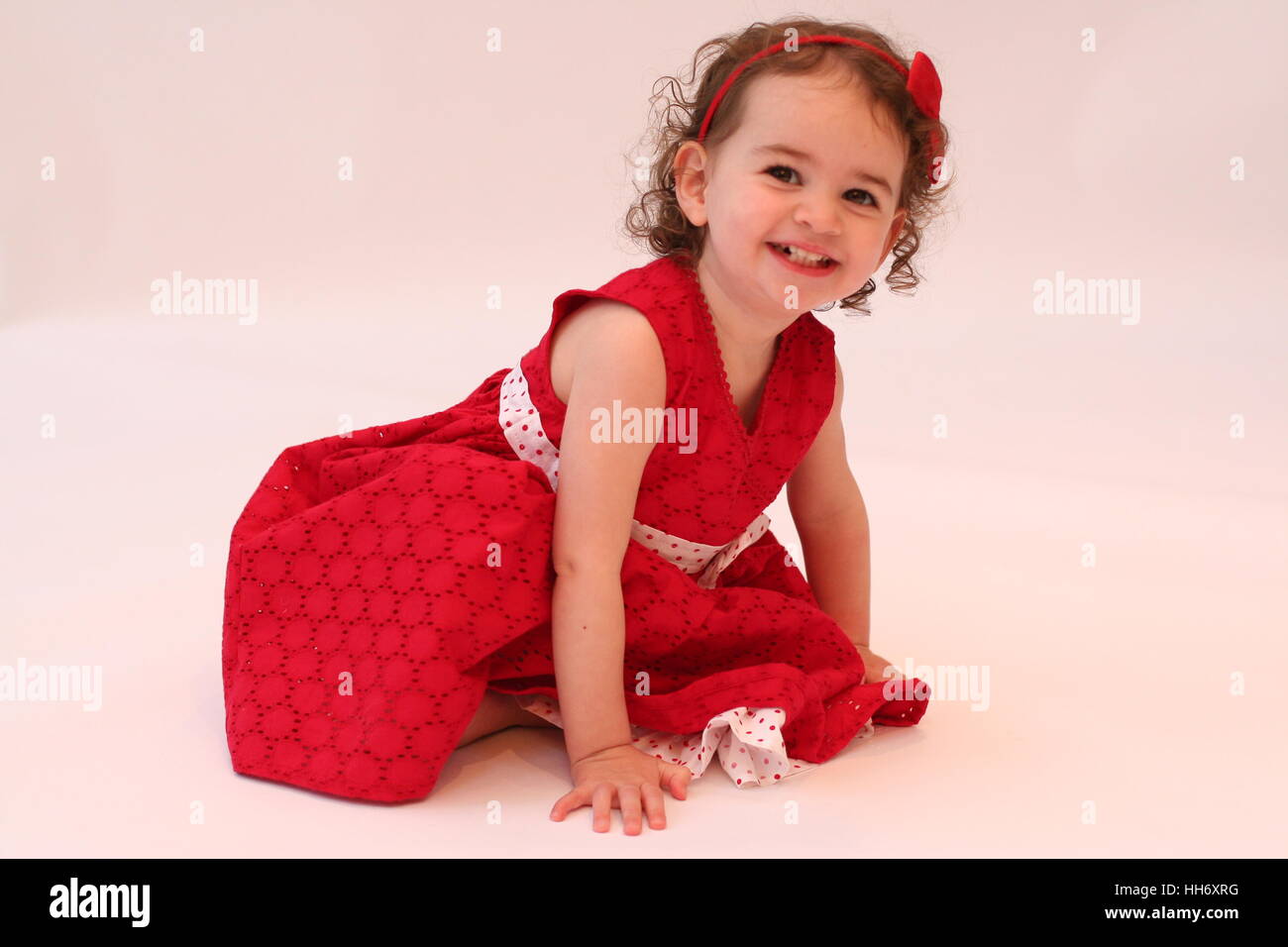 sweet little girl toddler, child curly hair, bare feet barefoot, dress, joy concept, happiness