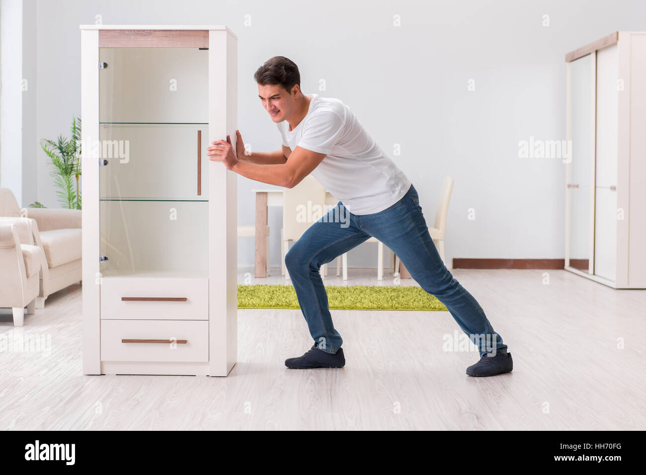 Man moving furniture at home Stock Photo Alamy