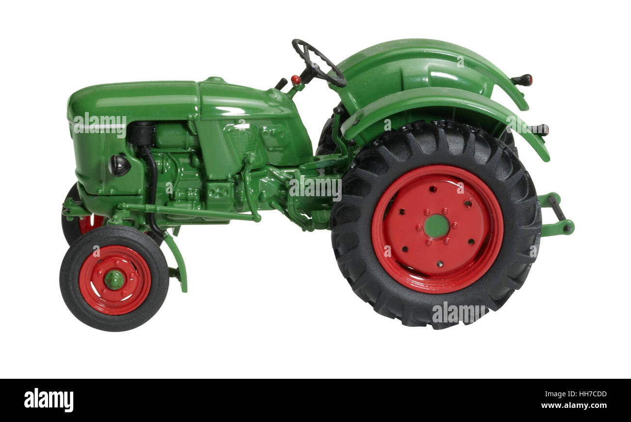 a nostalgic toy tractor isolated on white with clipping path Stock Photo