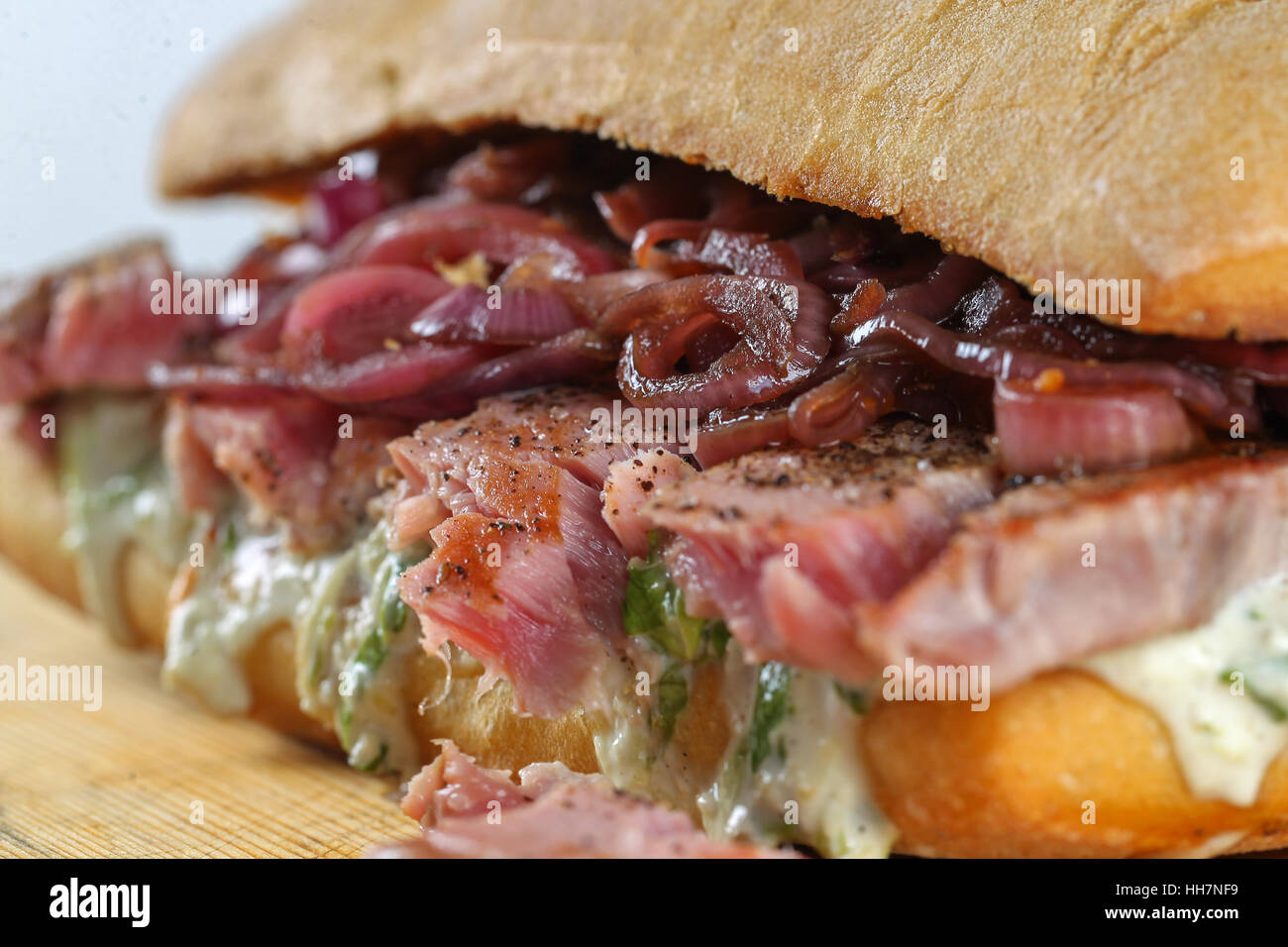 Tasty tuna steak sandwich in a ciabatta with lettuce, onions, Marie