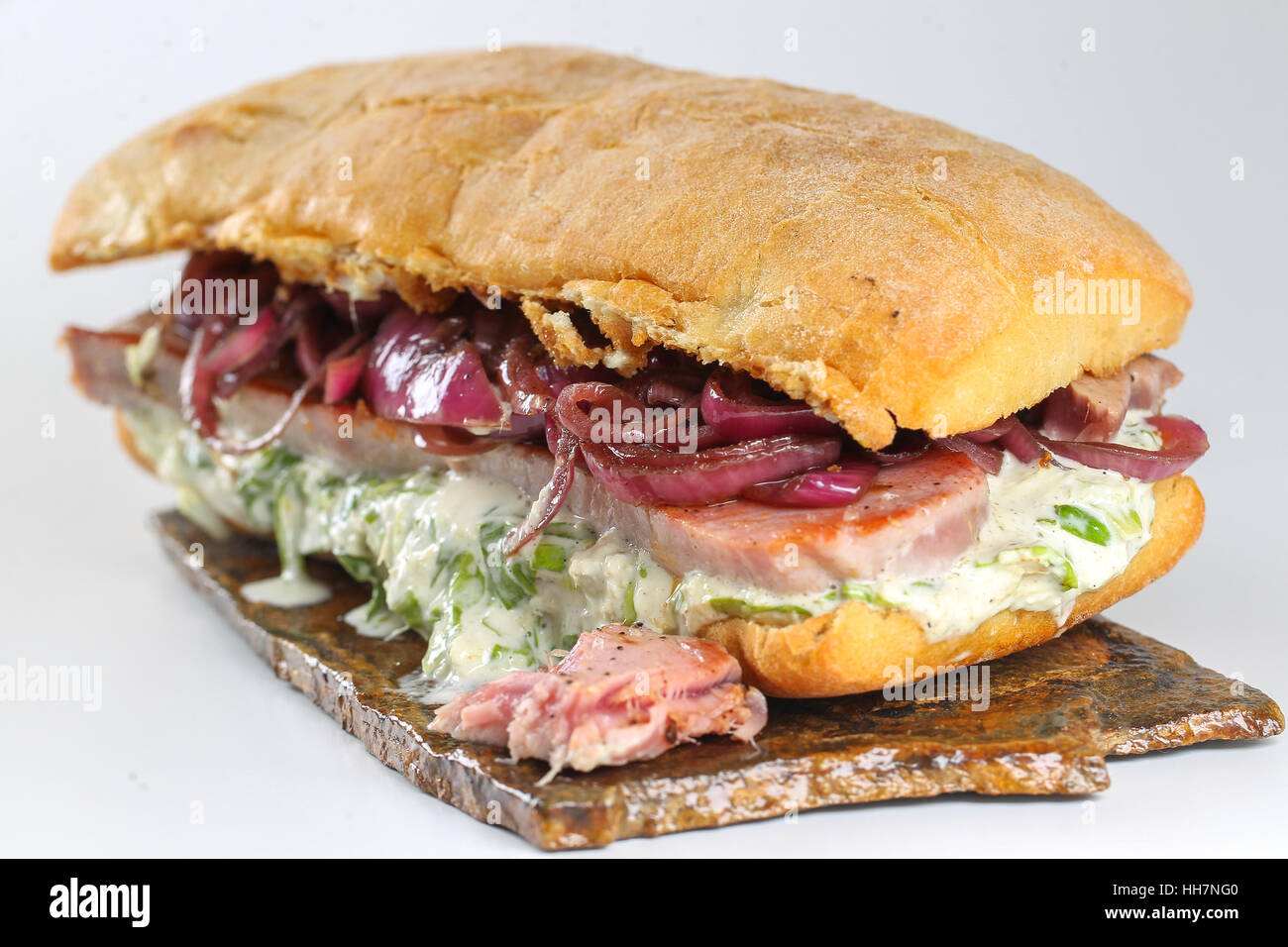 Tasty tuna steak sandwich in a ciabatta with lettuce, onions, Marie