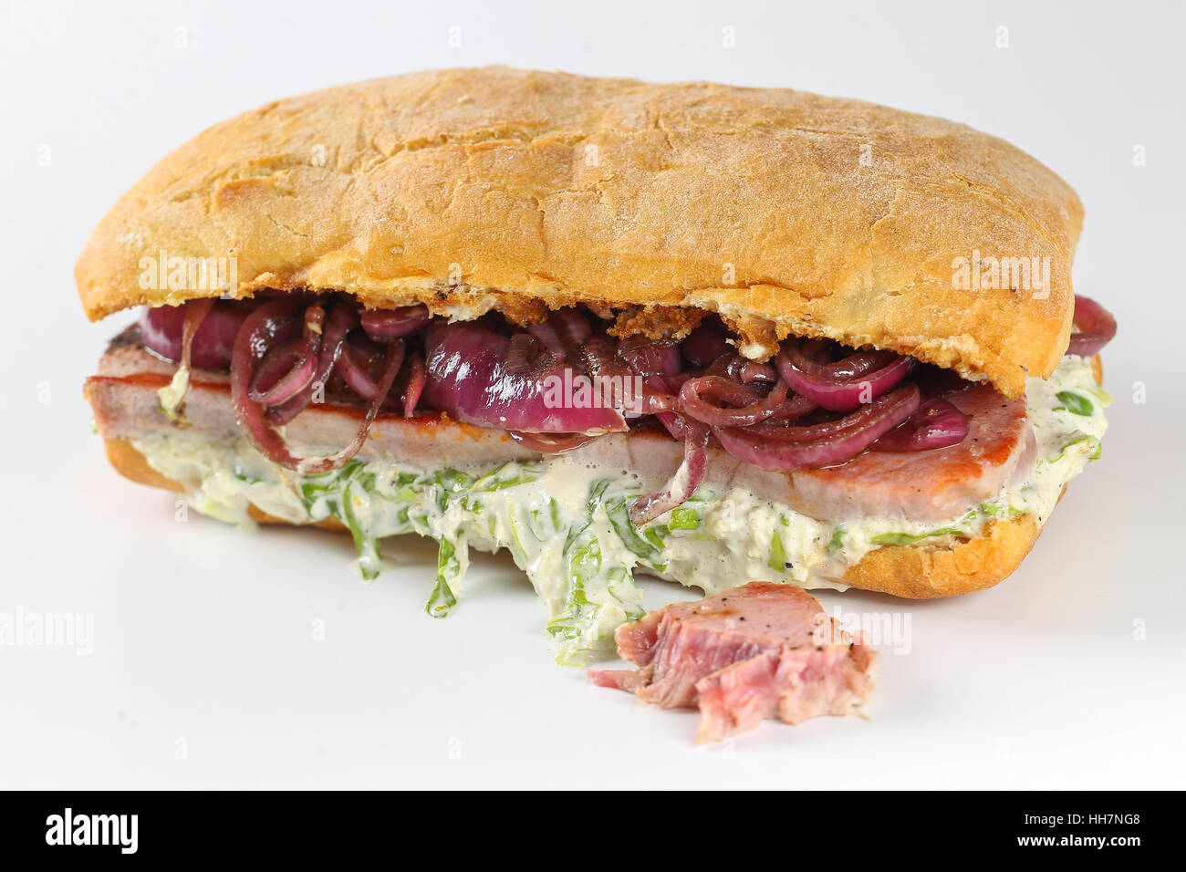 Tasty tuna steak sandwich in a ciabatta with lettuce, onions, Marie