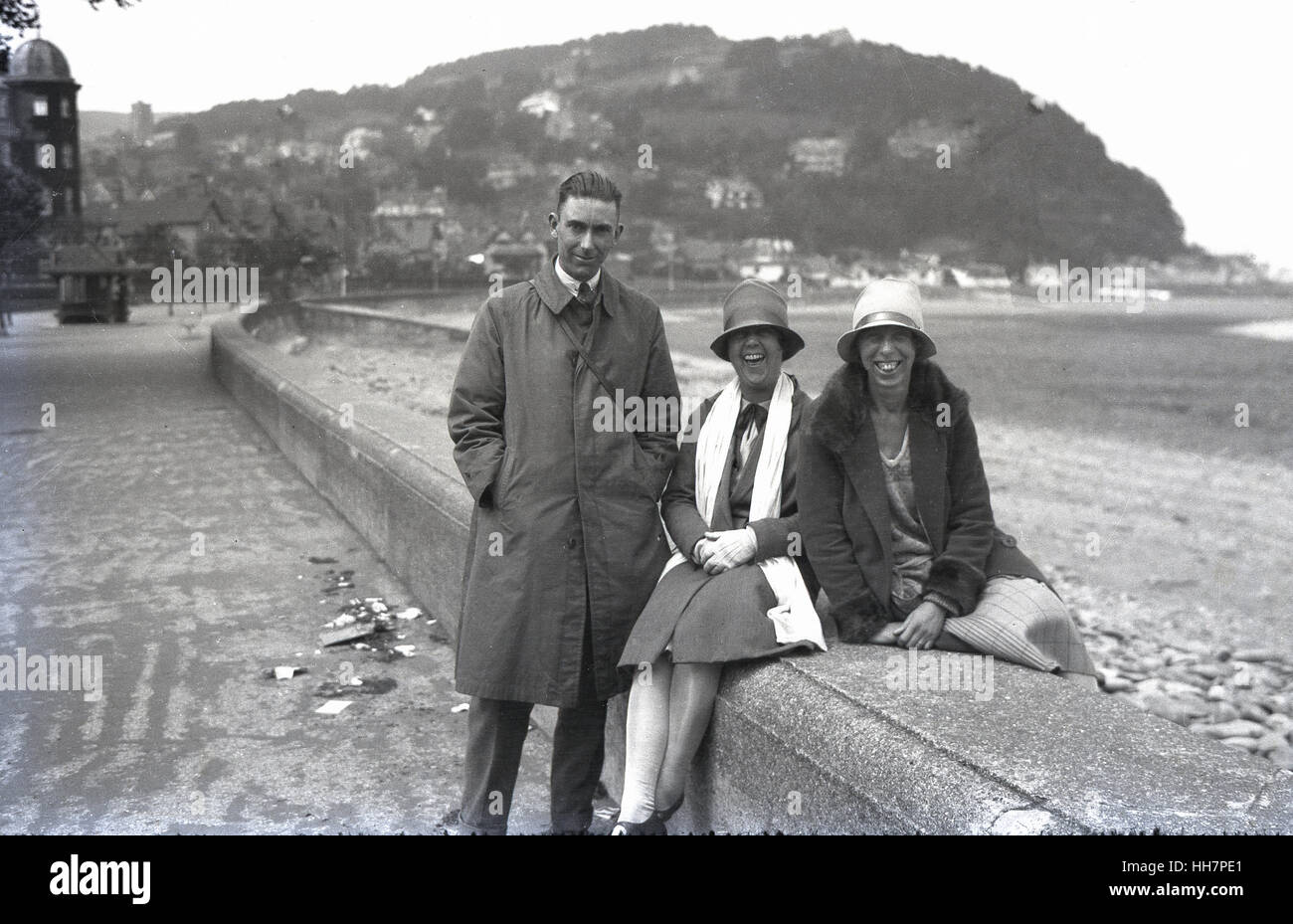 1920s, historical, a gentleman together with two smiling women sitting ...