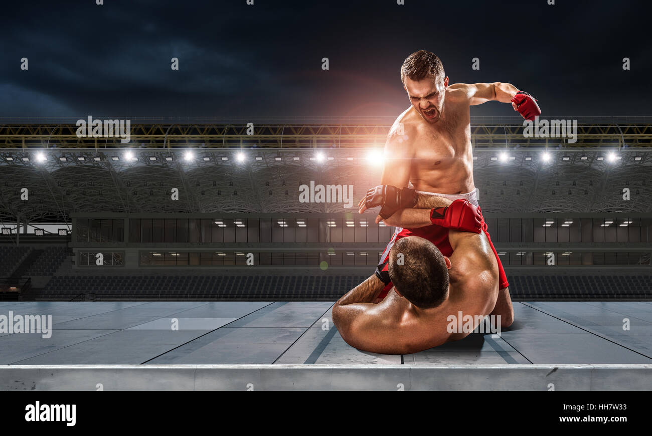 Two professional boxers fighting at sport arena. Mixed media Stock ...