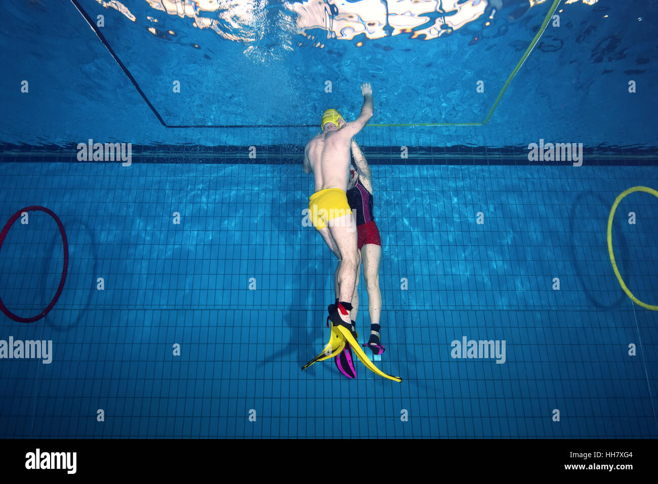 Underwater wrestling (Aquathlon) in swimming pool. Underwater view