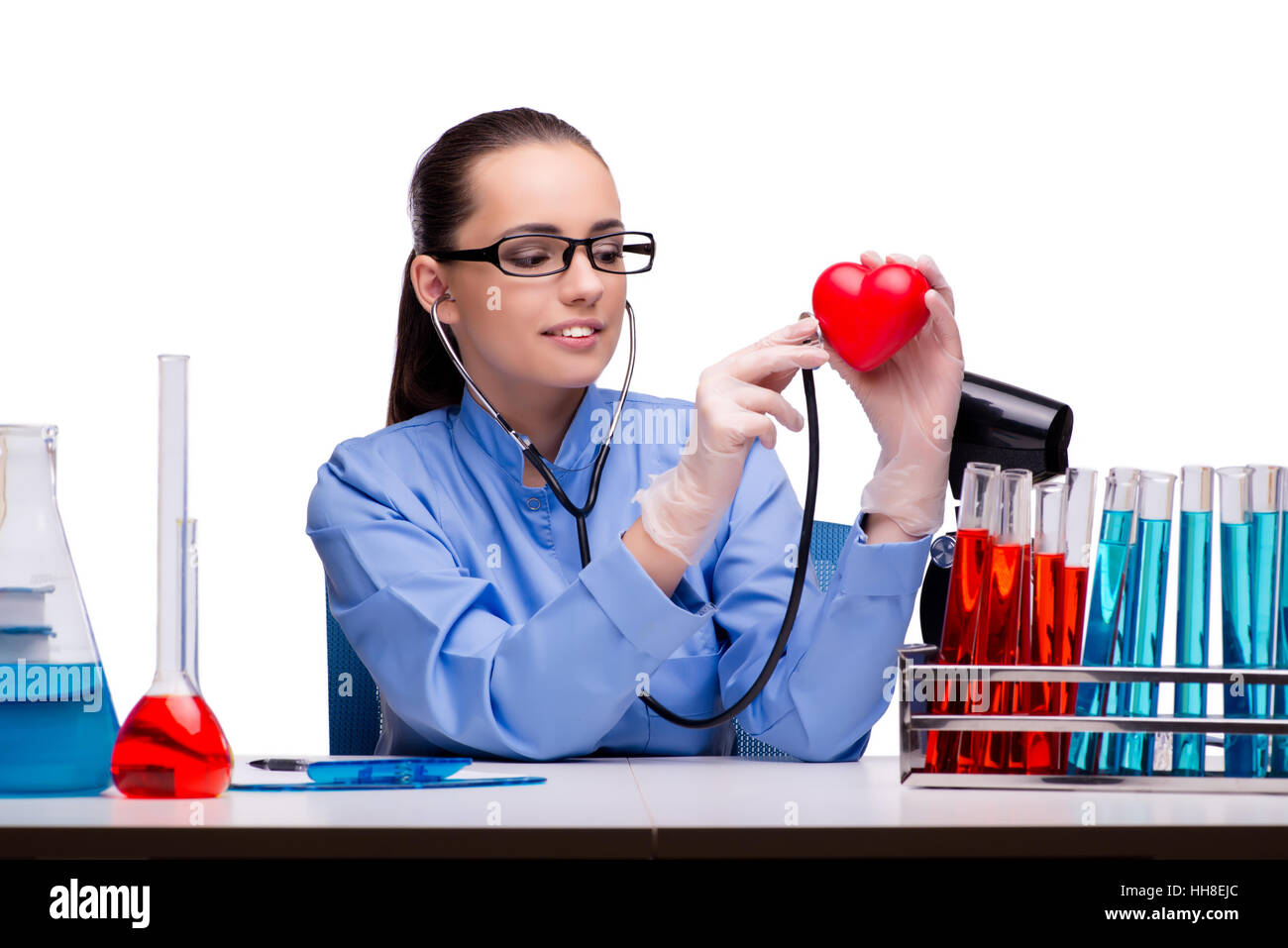 Young doctor with red heart isolated on white Stock Photo - Alamy