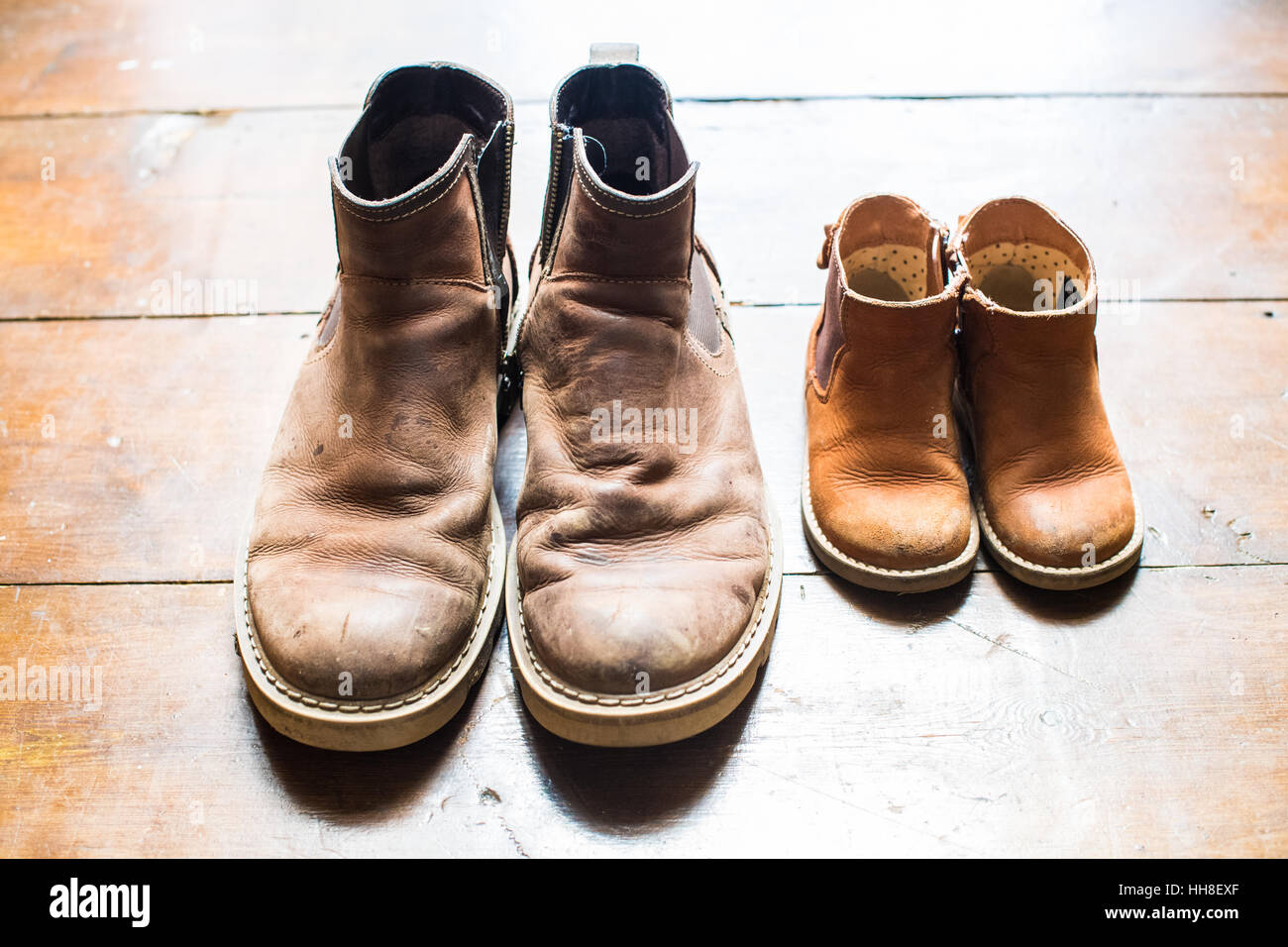 Father and son boots in the doorway Stock Photo