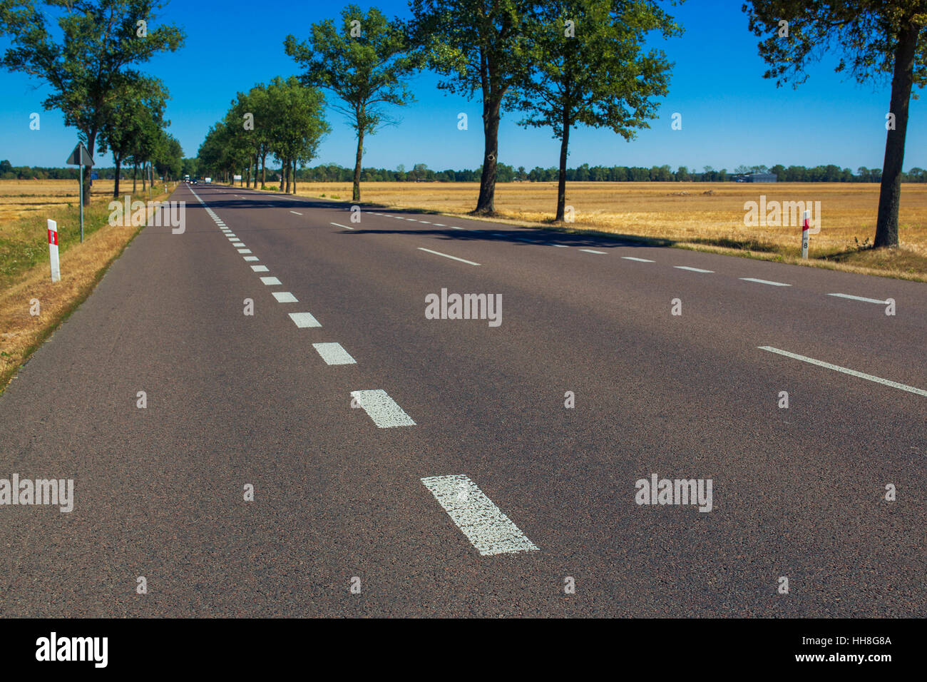 New road in Poland. Good quality road building concept. Focus on asphalt on foreground. Stock Photo