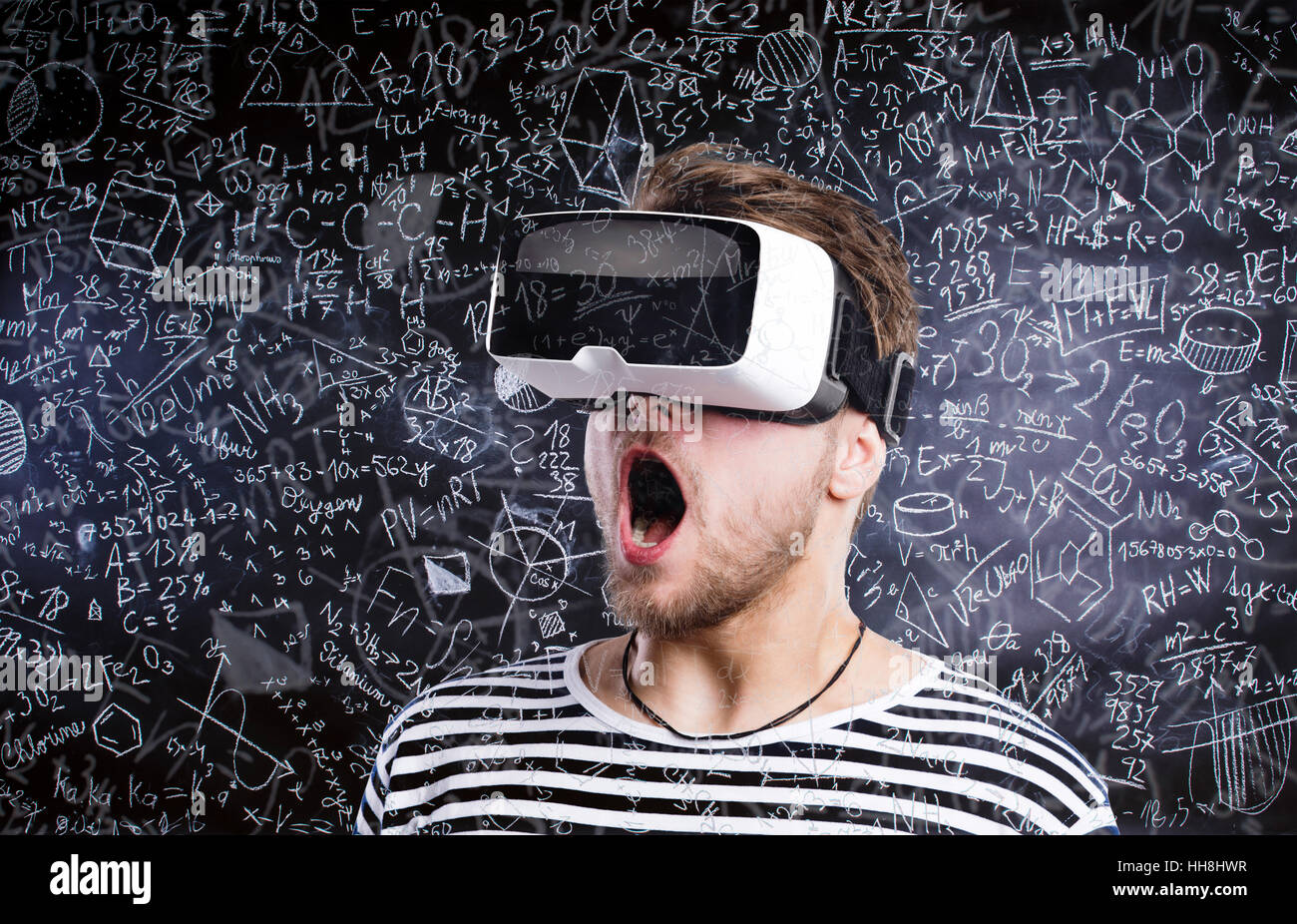 Double exposure. Man wearing virtual reality goggles. Blackboard Stock ...