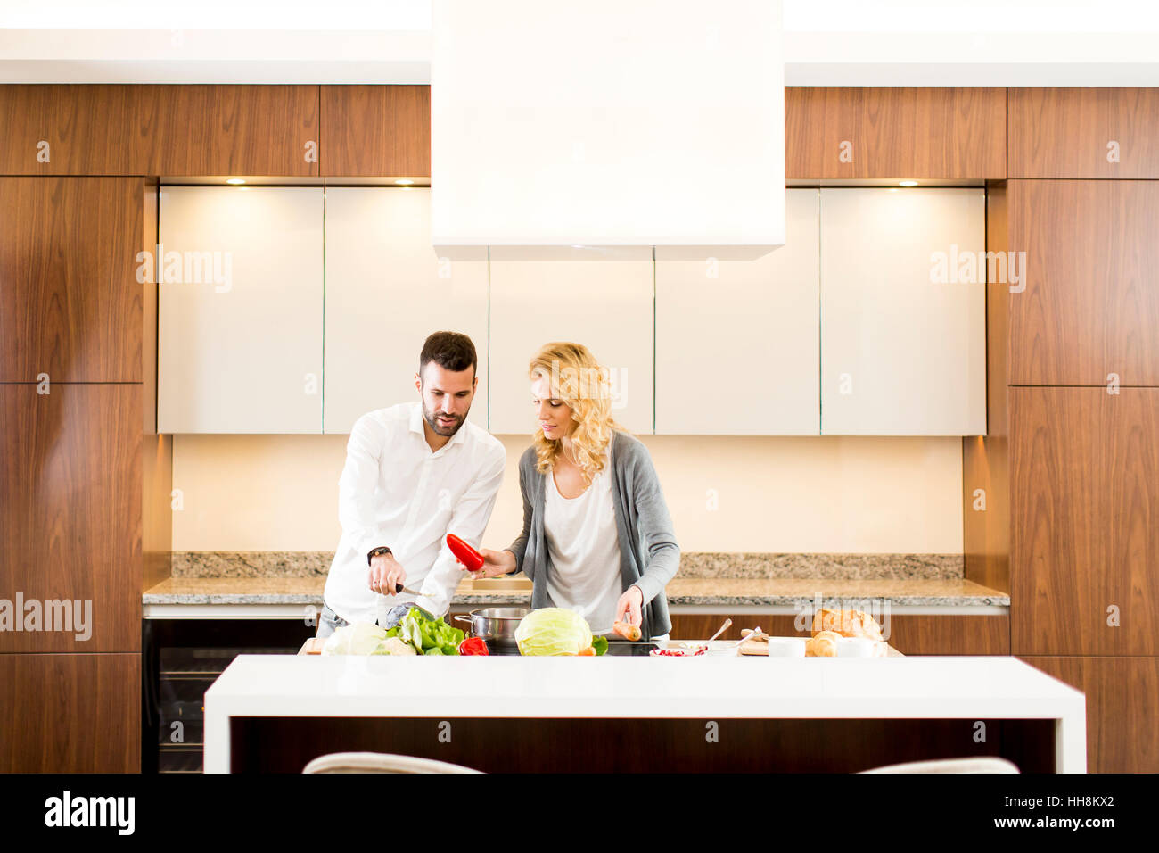 Young loving couple  preparing  tasty meal in a modern kitchen Stock Photo