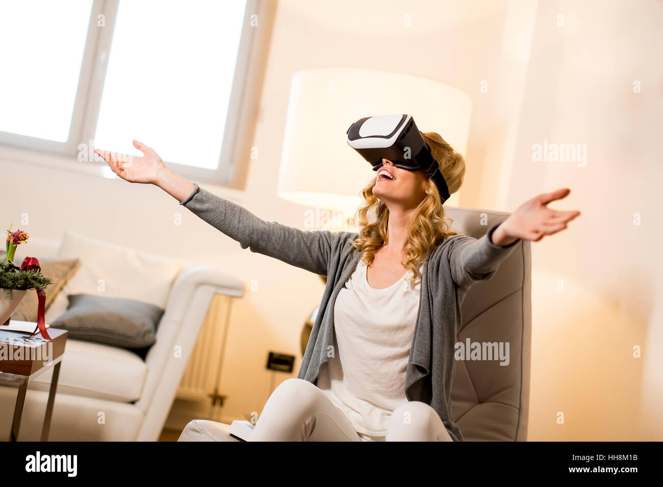 Woman wearing virtual reality goggles in the room Stock Photo