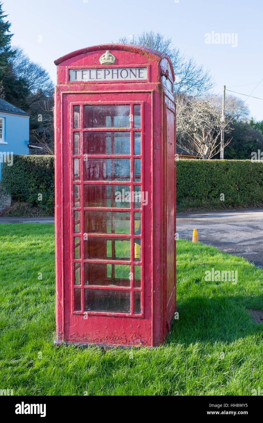 Old red telephone box on the green in the village of Batson near Salcombe in Devon Stock Photo