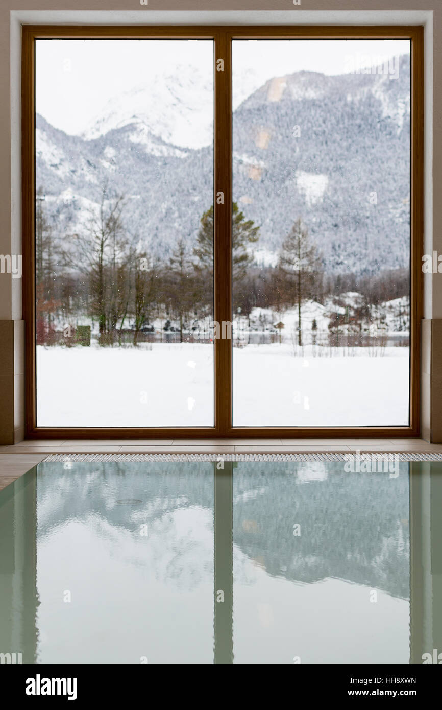 Swimming Pool with Snow Covered Mountain Lake View. Winter Idyll Window. Stock Photo