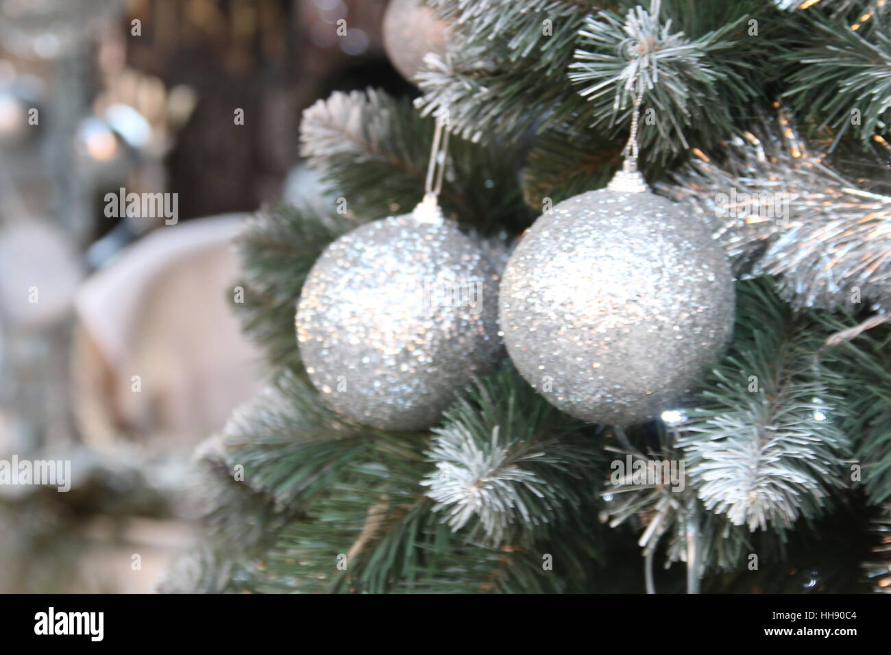 Decorations for Christmas and New Year day. Silver Christmas balls on tree branches Stock Photo