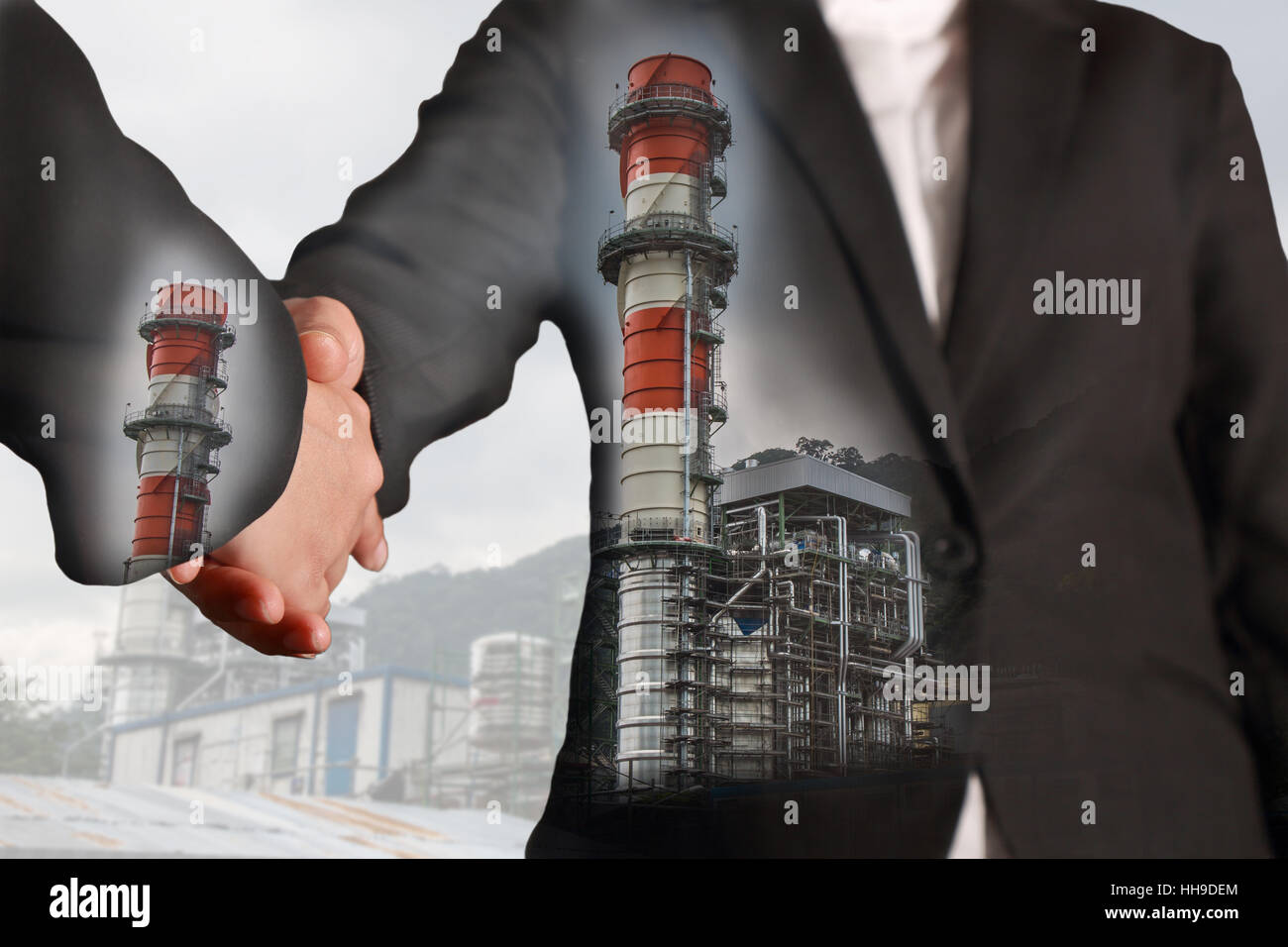 Double exposure of handshake and Electric Generating Factory Stock Photo