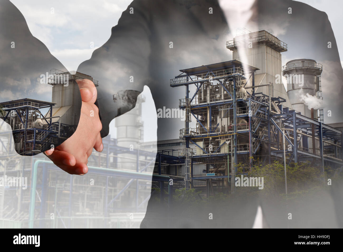 Double exposure of handshake and Power Reactor Factory Stock Photo