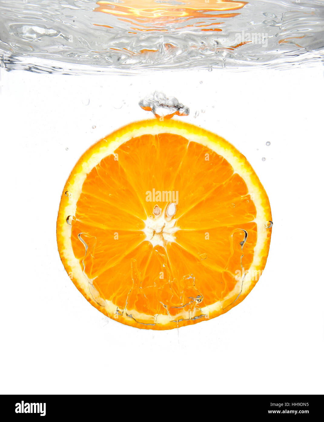 Fresh orange slice splashing into transparent water Stock Photo - Alamy