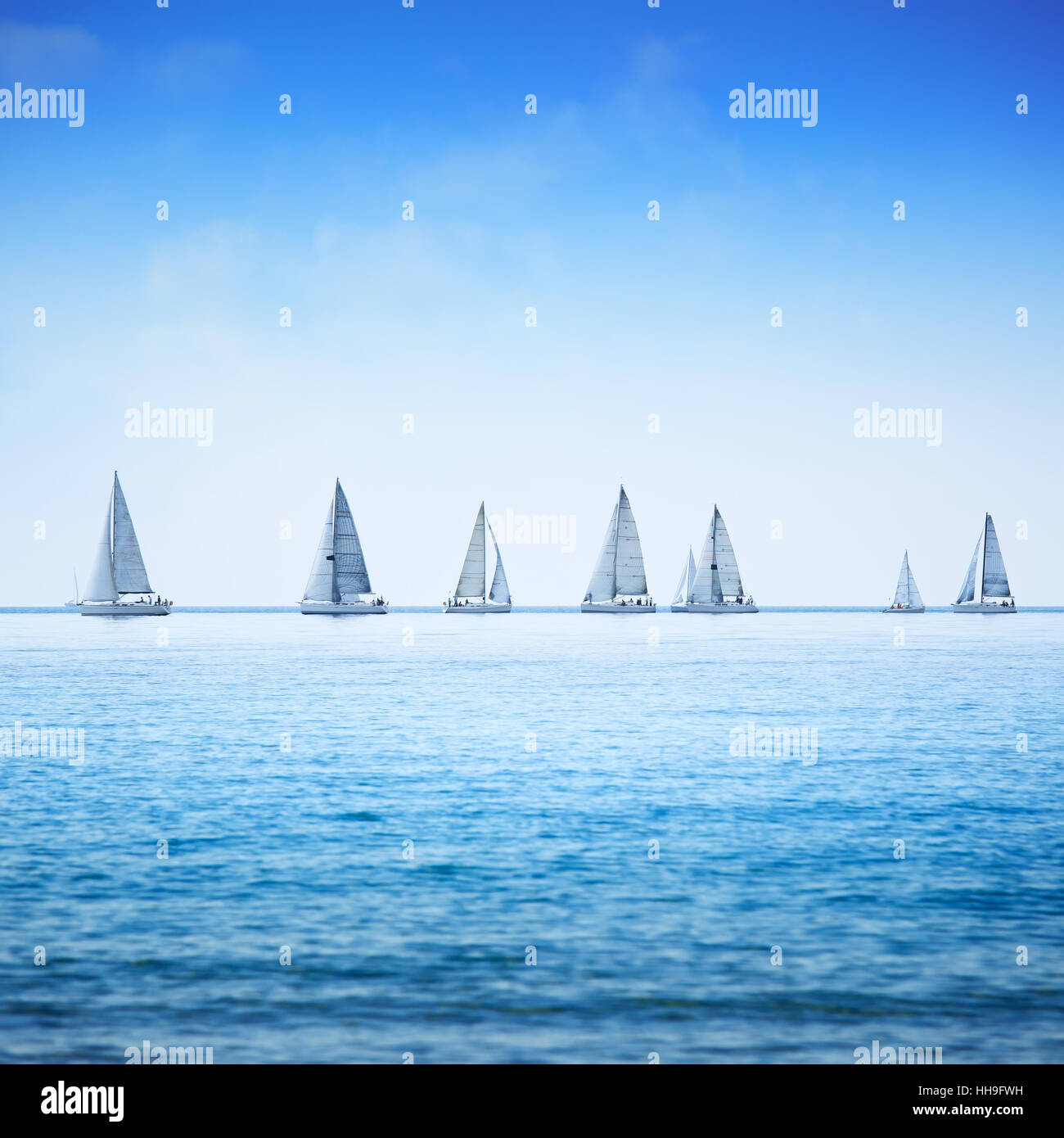 Sailing boat yacht or sailboat group regatta race on sea or ocean water. Stock Photo
