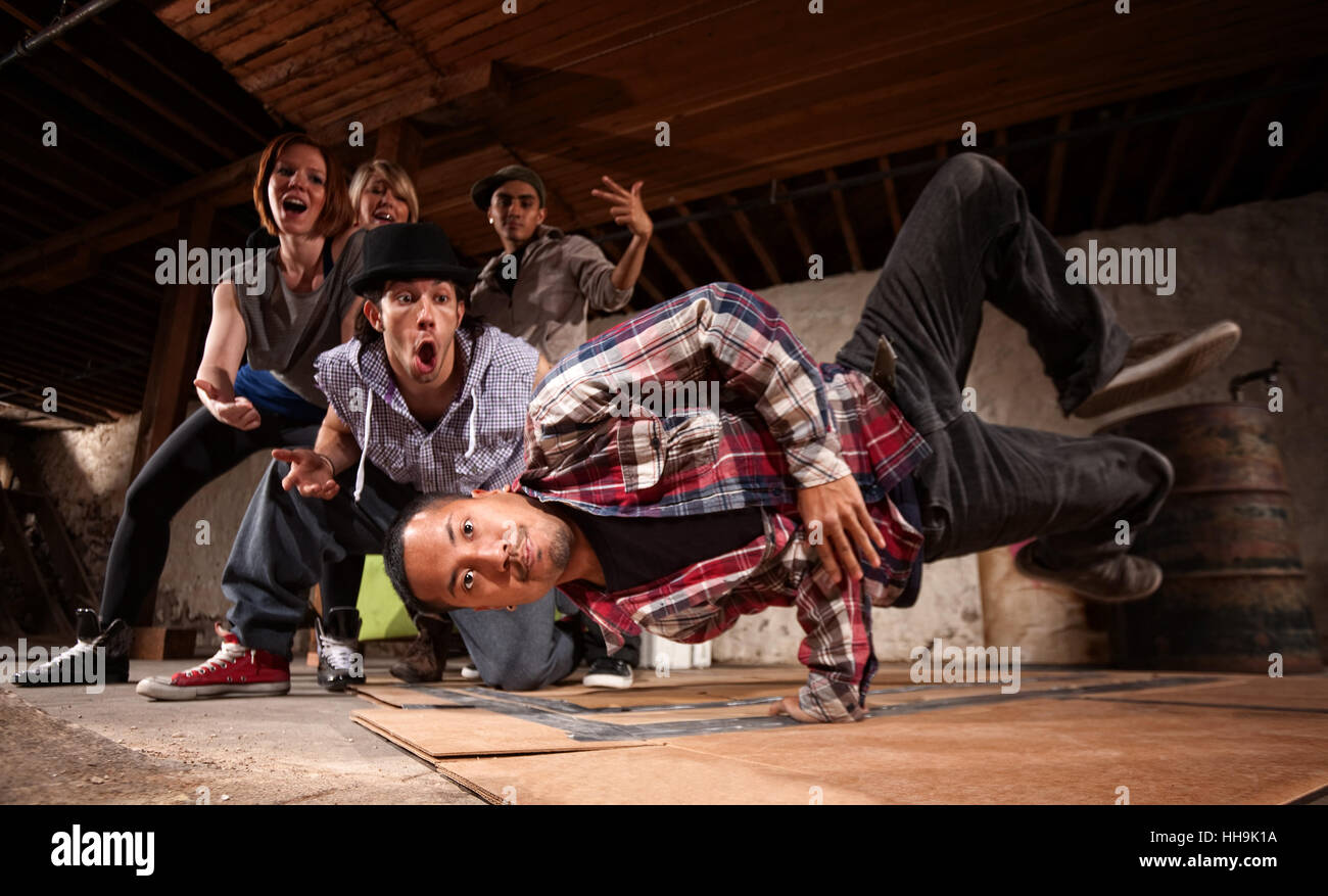 Young Asian man performs break dancing moves on cardboard Stock Photo