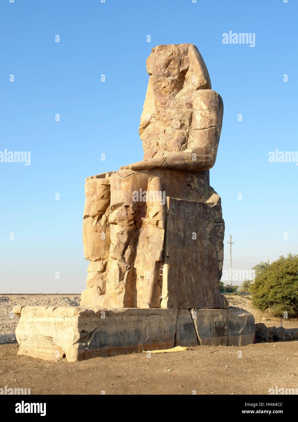 southern statue of the Colossi of Memnon, two huge ancient statues near Luxor in Egypt (Africa) at evening time Stock Photo