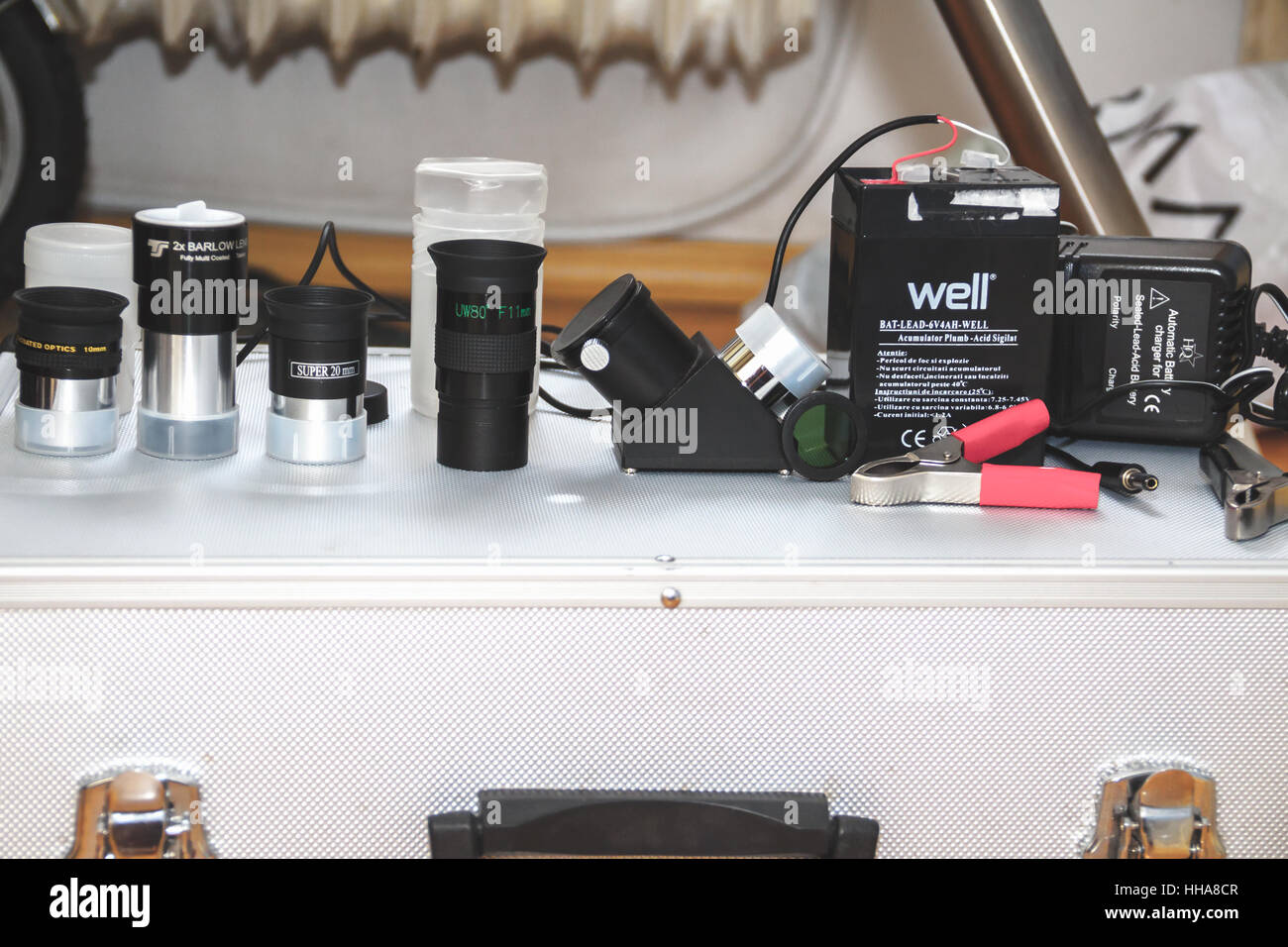 varied type of oculars for telescopes and acid batteries on a metallic