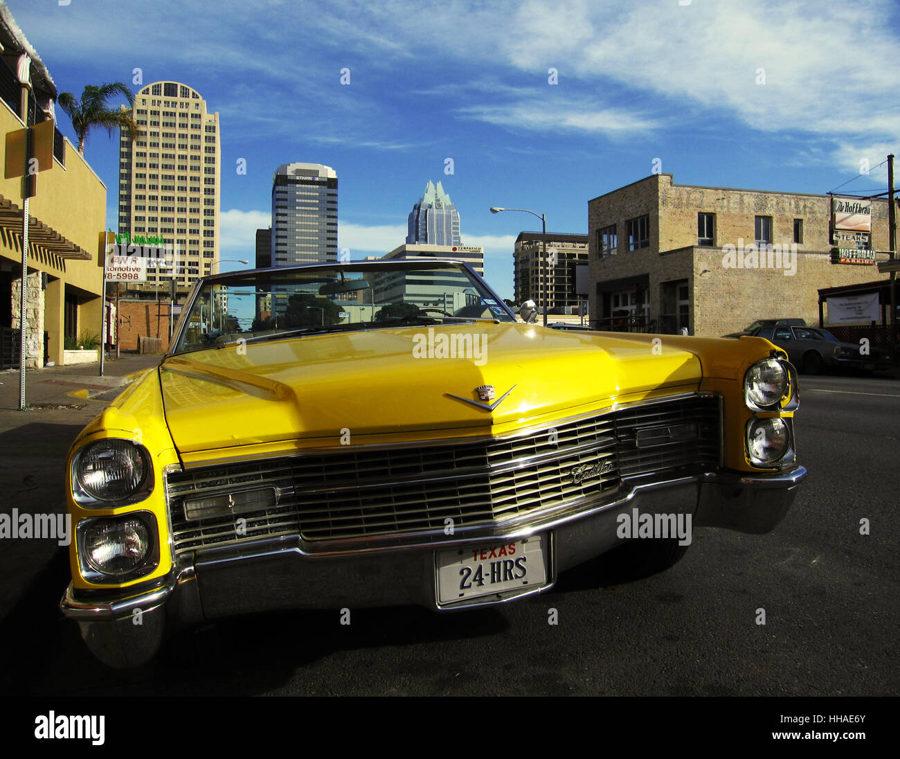 A vintage yellow Cadillac parked on the street in downtown Austin