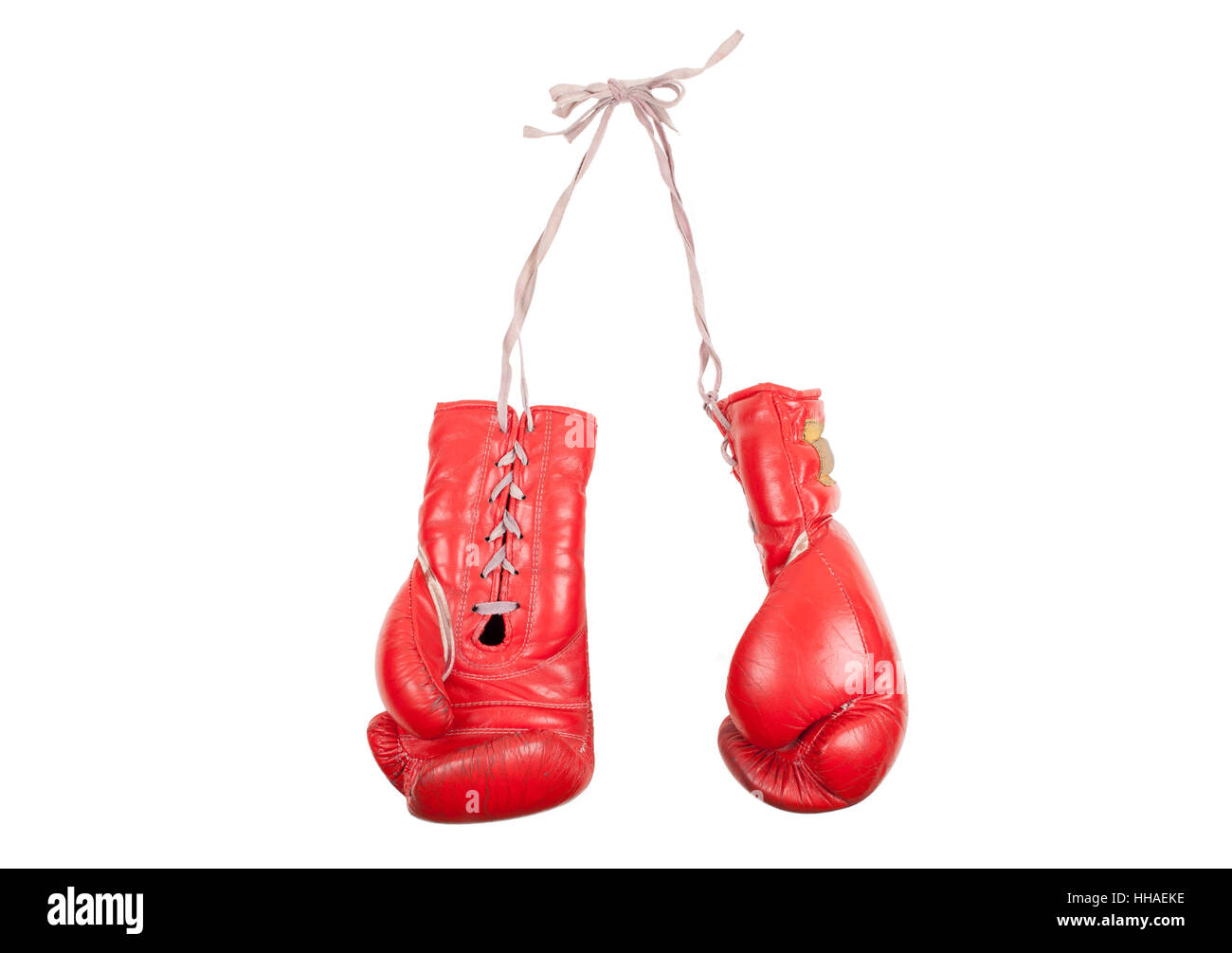 used and battered red leather boxing gloves, isolated on white background Stock Photo