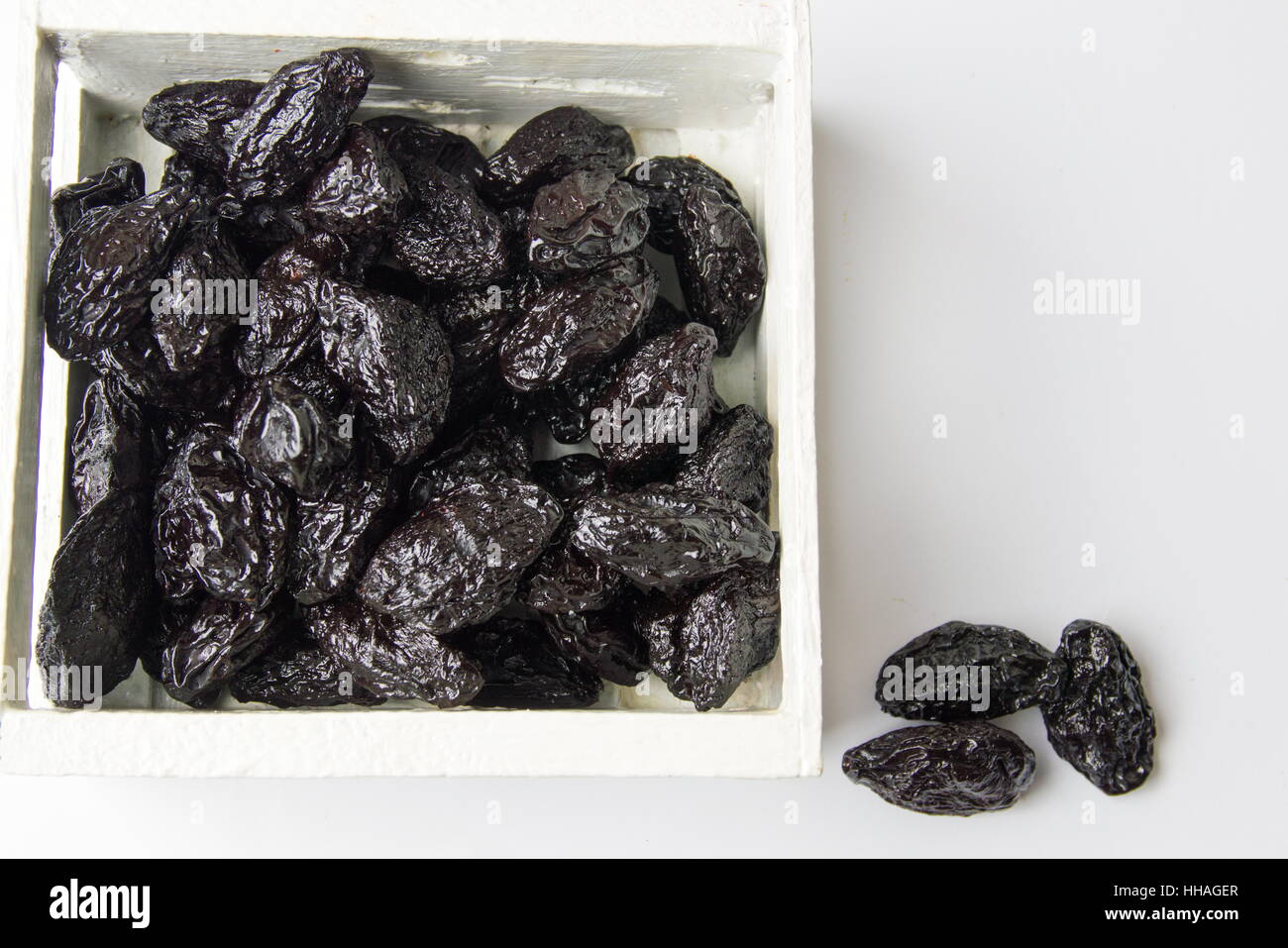 Bunch of dried plum fruits in a wooden box Stock Photo