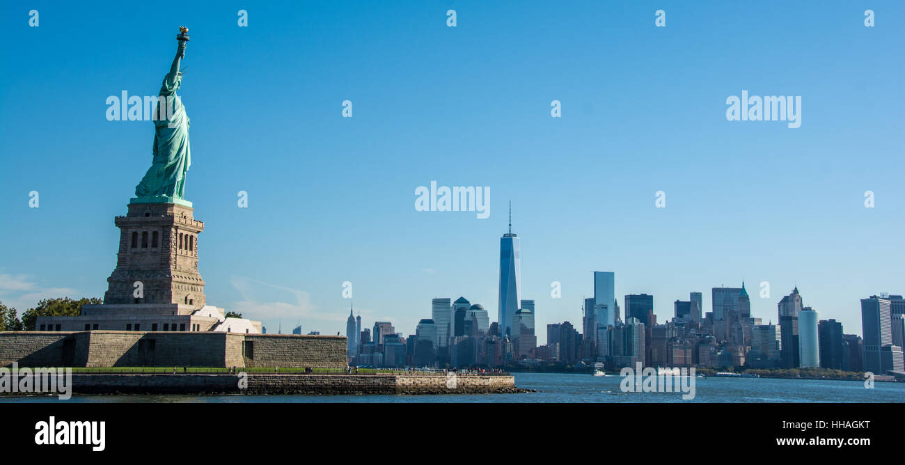 A view of the Statue of Liberty and lower Manhattan skyline in the background, New York City Stock Photo