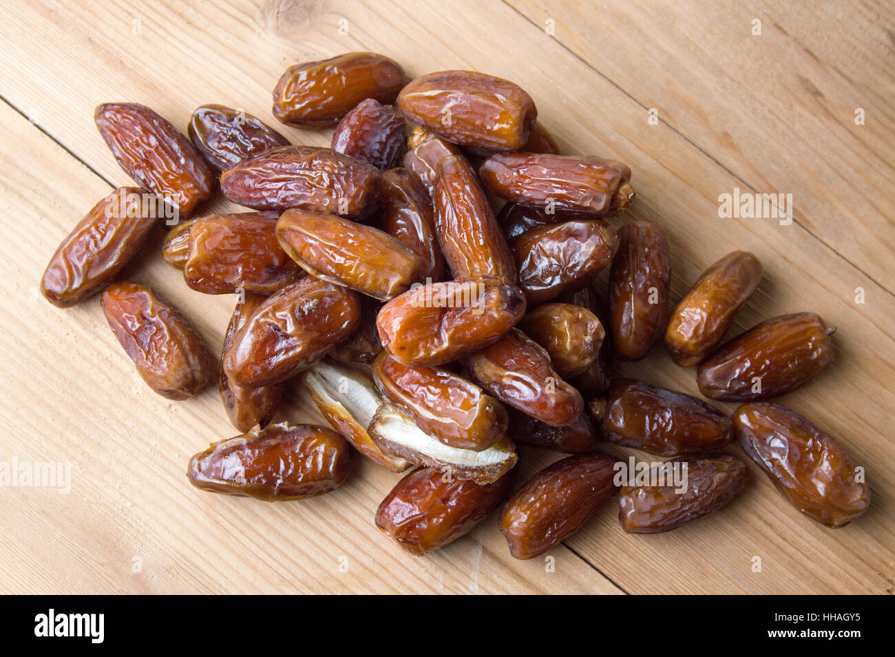 Bunch of dried date fruits on wooden table Stock Photo