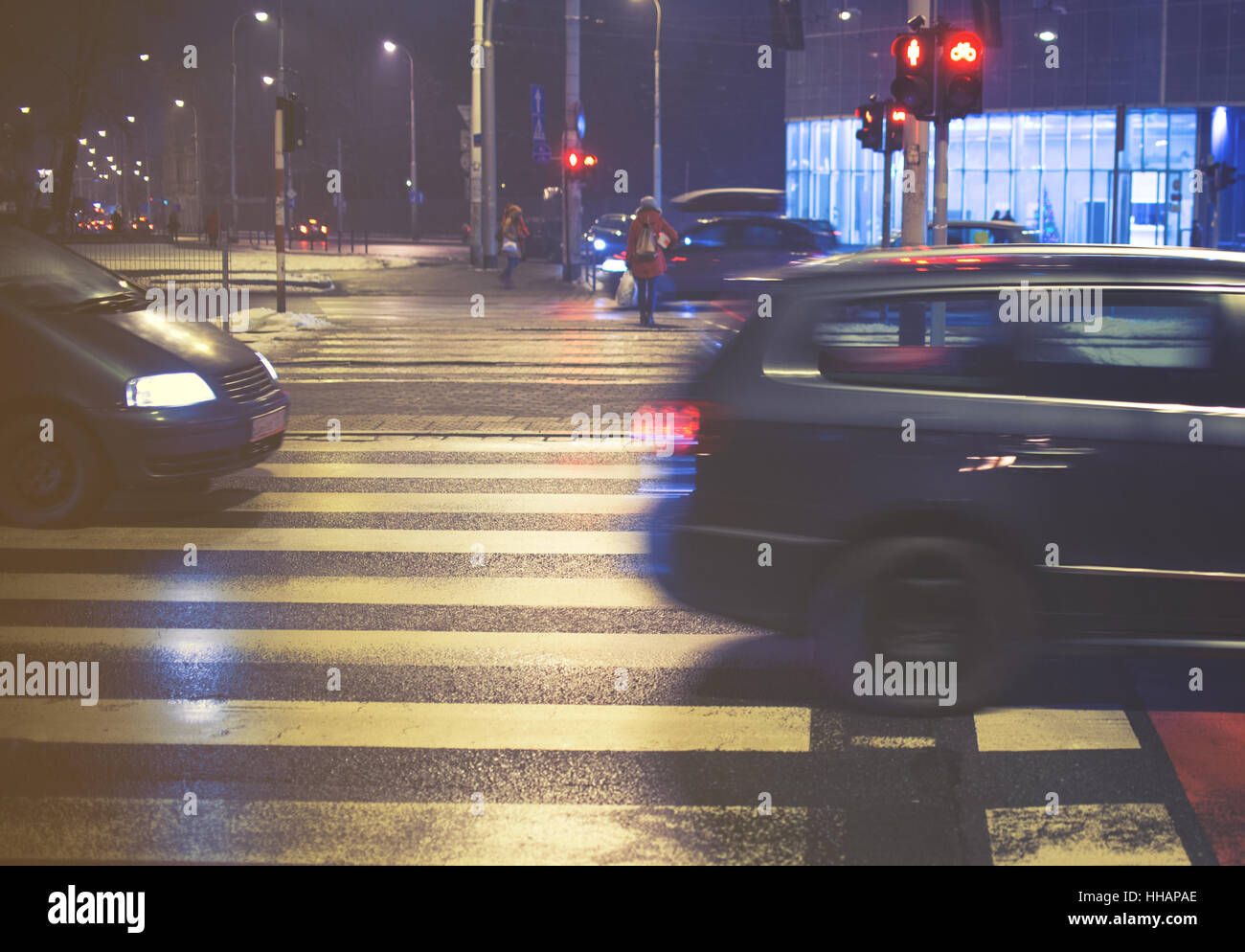 two cars on the pedestrian crossing, motion blur, night Stock Photo - Alamy