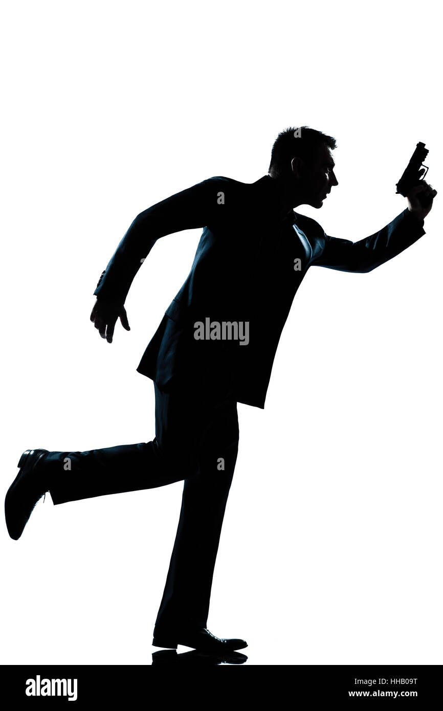spy criminal policeman detective  man running holding gun full length silhouette in studio isolated white background Stock Photo