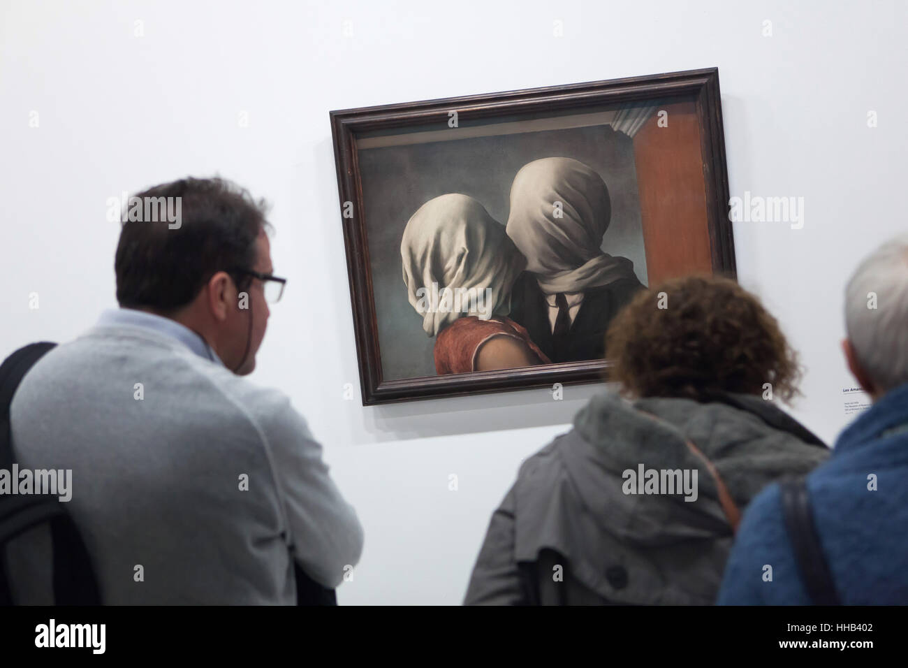 Visitors in front of the painting Les Amants (The Lovers, 1928) by Belgian surrealist artist Rene Magritte displayed at his retrospective exhibition in the Centre Pompidou in Paris, France. The exhibition entitled 'Rene Magritte. The Treachery of Images' runs till 23 January 2017. After that the reformulated version of the exhibition will be presented at the Schirn Kunsthalle in Frankfurt am Main, Germany, from 10 February to 5 June 2017. Stock Photo