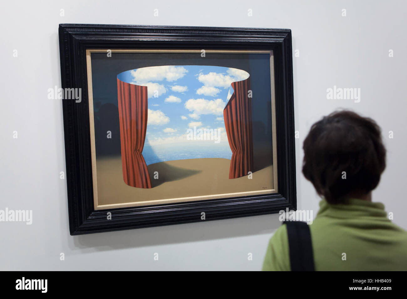 Visitor in front of the painting Les Memoires d'un saint (Memories of a Saint, 1960) by Belgian surrealist artist Rene Magritte displayed at his retrospective exhibition in the Centre Pompidou in Paris, France. The exhibition entitled 'Rene Magritte. The Treachery of Images' runs till 23 January 2017. After that the reformulated version of the exhibition will be presented at the Schirn Kunsthalle in Frankfurt am Main, Germany, from 10 February to 5 June 2017. Stock Photo