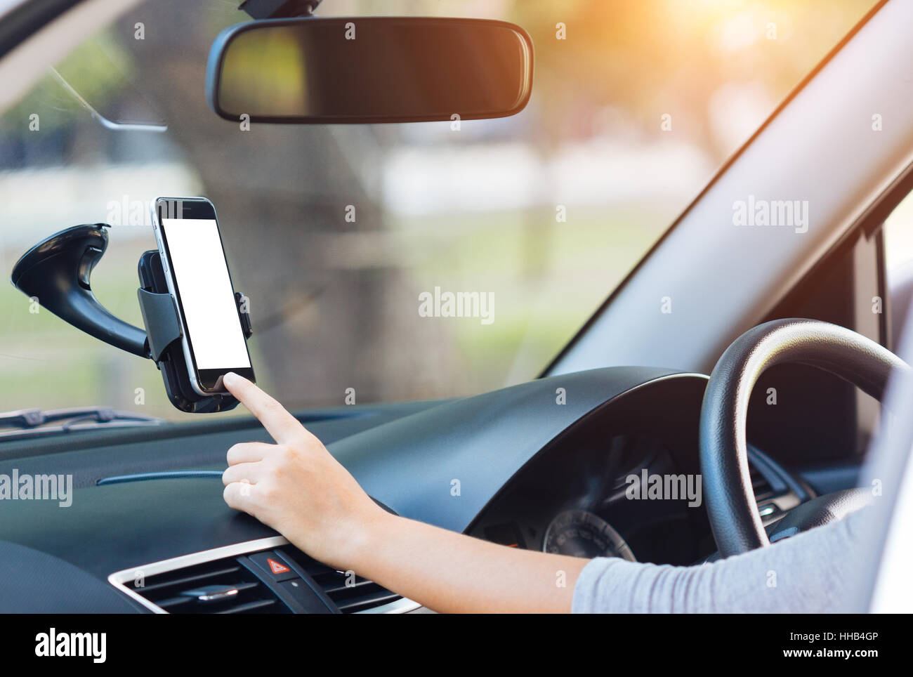 hand touching on phone mobile white screen in car Stock Photo