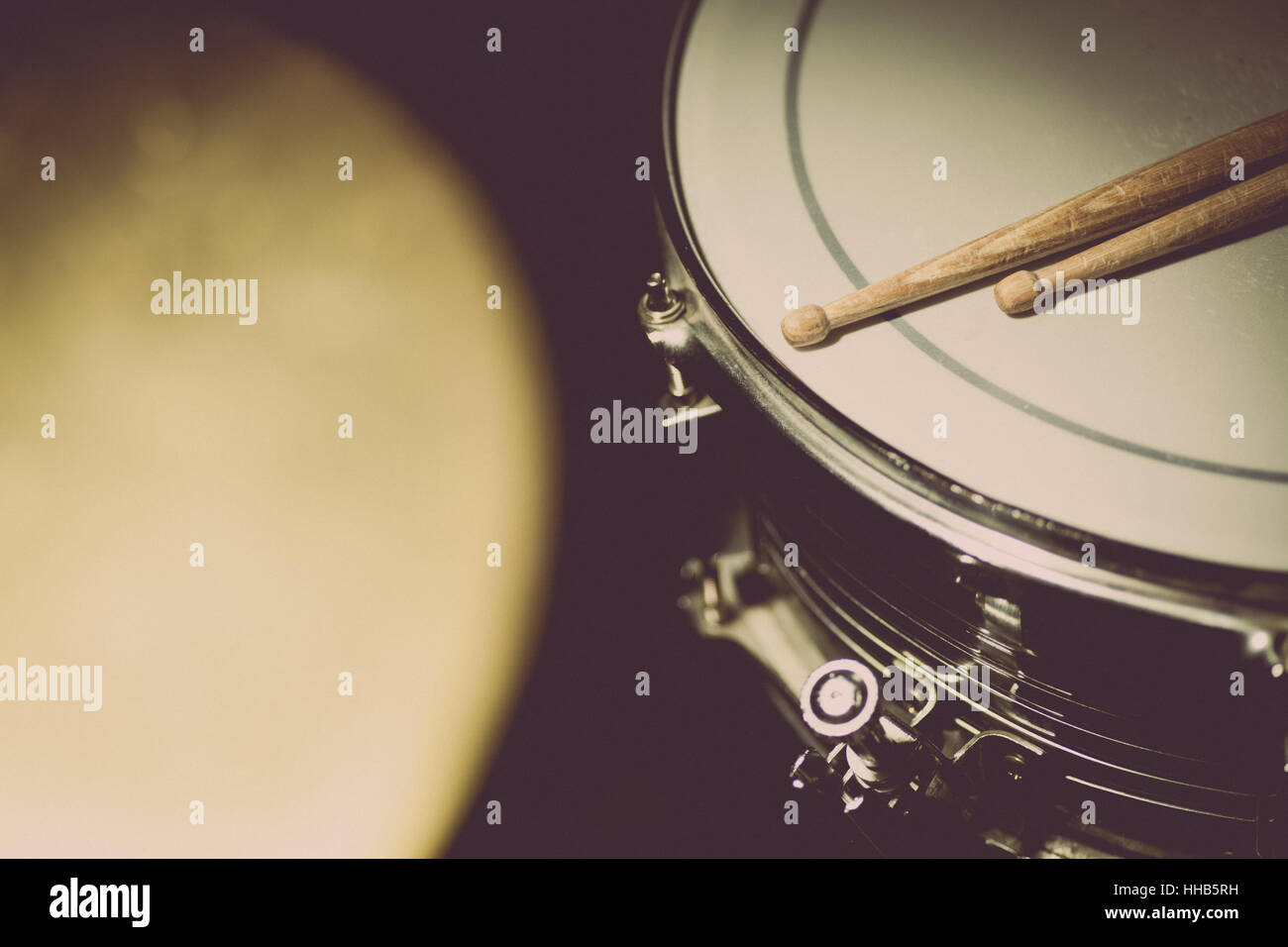 A snare drum and a pair of drumsticks. Stock Photo