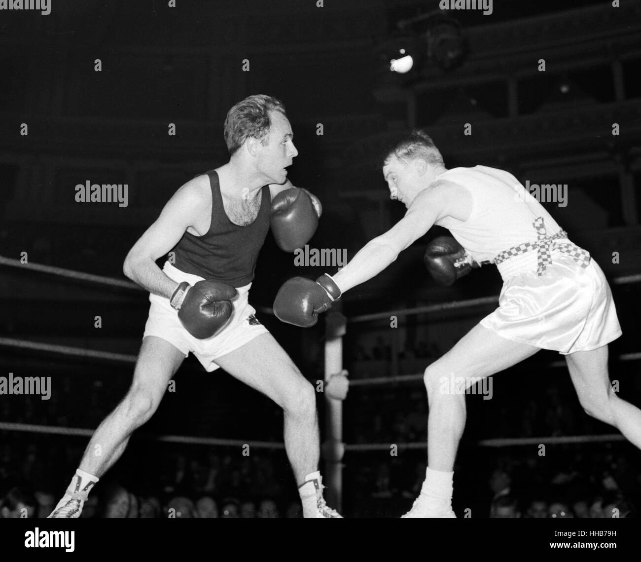 R Russell (right) of Hull Boys' Club forces Manfred Mae (Berlin) to retreat in their featherweight bout in the international amateur boxing match between England and West Germany at the Royal Albert Hall, London. Mae won, the referee stopping the fight in the second round because of  a cut eye sustained by Russell. Stock Photo