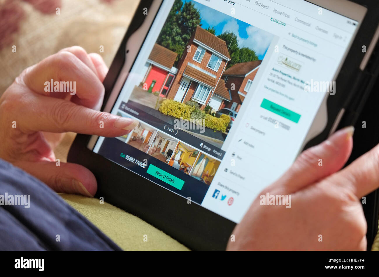 online property search using tablet computer Stock Photo