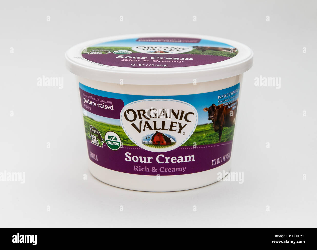 A single tub of sour cream by Organic Valley is seen against white background. Stock Photo
